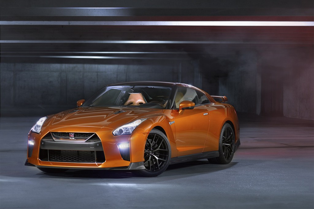 The 2017 GT-R's exterior receives a thorough makeover. The new V-motion grille, one of Nissan's latest design signatures, has been slightly enlarged to provide better engine cooling and now features a matte chrome finish and an updated mesh pattern. A new hood, featuring pronounced character lines flowing flawlessly from the grille, has been reinforced to enhance stability during high-speed driving. A freshly designed front spoiler lip and front bumpers with finishers situated immediately below the headlamps give the new GT-R the look of a pure-bred racecar, while generating high levels of front downforce.