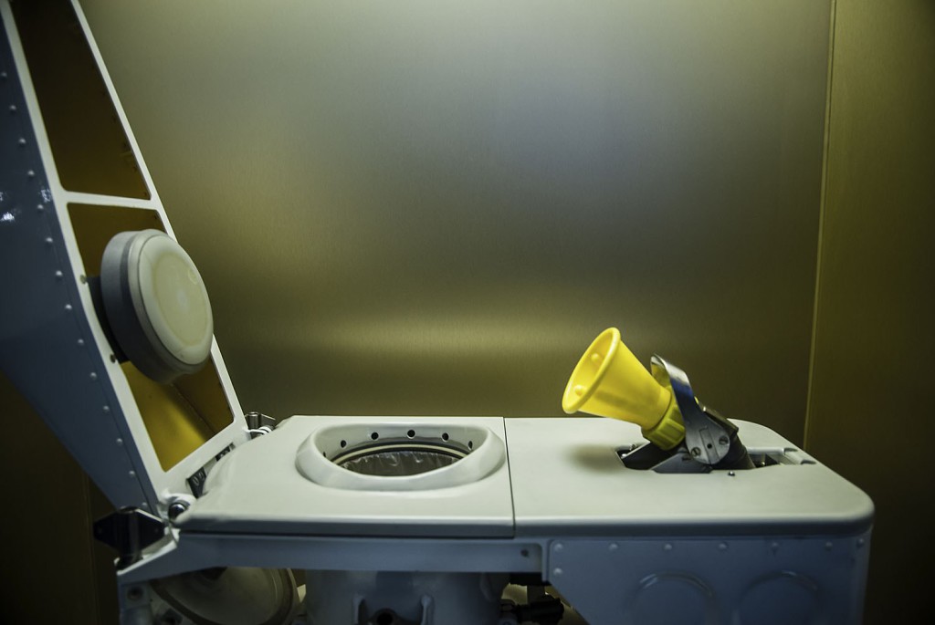 A side profile view of a toilet designed for use in space